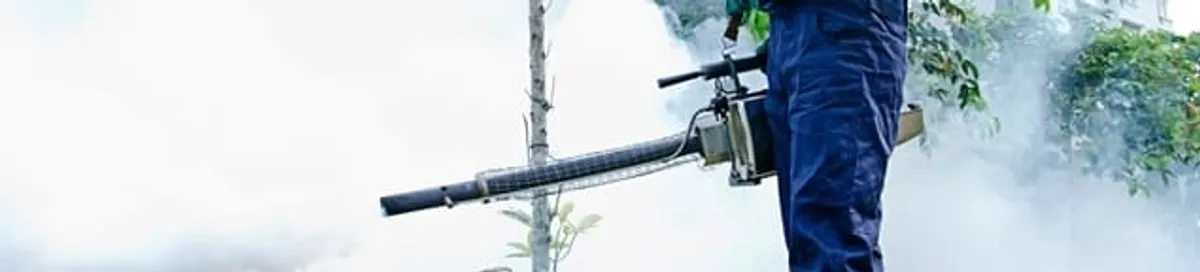 Pest control technician fogging an outdoor area for insect control in Anchorage, AK